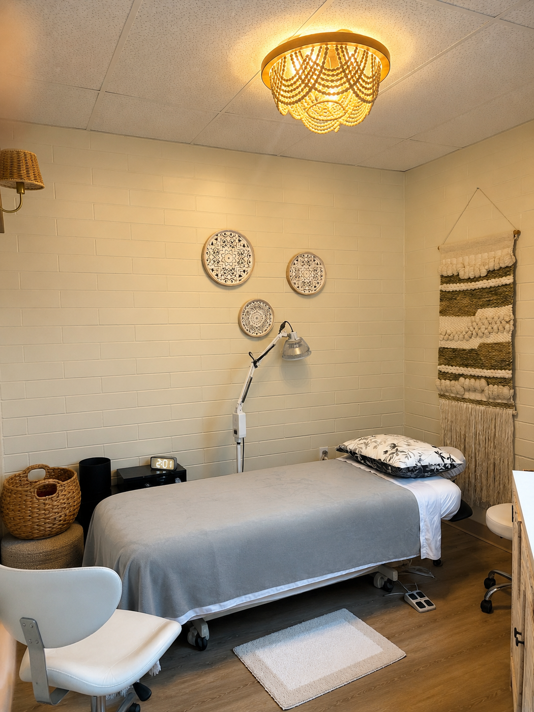 Private acupuncture treatment room at Victoria Healing Space in Victoria BC with an electric treatment table, infrared therapy lamp and Traditional Chinese Medicine equipment.